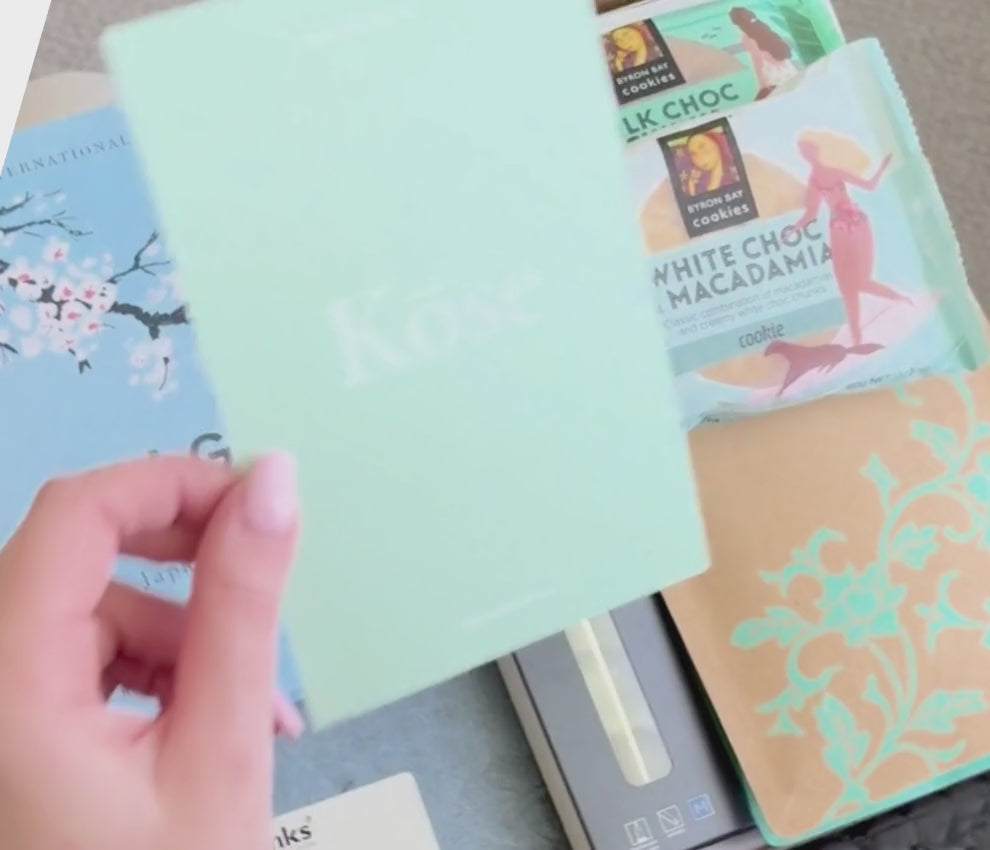 Load video: Book box filled with a book, a journal, pen, tea and a chocolate.